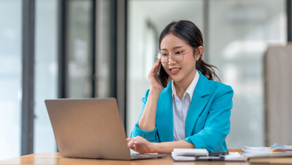 Asian businesswoman modern professional talking with client on the phone with a confident demeanor and effective communication skill. business, marketing, sale and communication project.