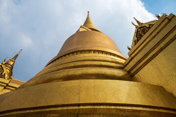 Gold covered stupa, Phra Siratana Chedi, from close angle at the temple of the Emerald Buddha in...