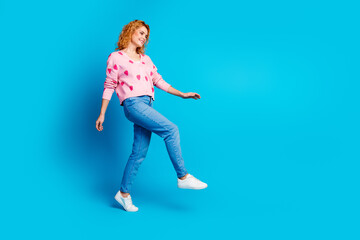 Obraz premium Full length photo of attractive young woman model walking dressed stylish pink clothes isolated on blue color background