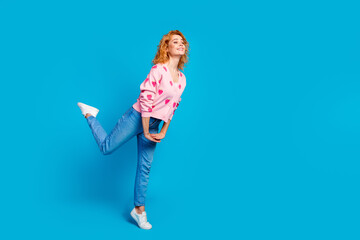 Full body photo of pretty young girl look excited girlish empty space wear trendy pink outfit isolated on blue color background