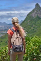 Woman is hiking in mountains. Travel adventure during vacation, outdoor healthy lifestyle and eco tourism