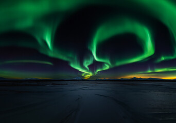 Colors dance across the sky in an aurora display.