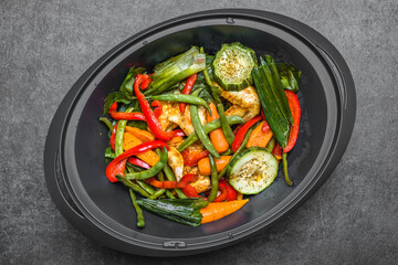 Stir fry vegetables with chicken wings. Spicy asian food preparing.