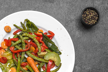 Asian food. Plate of stir fry vegetables. Fried zucchini, green bean, carrots, pepper. Healthy diet concept.
