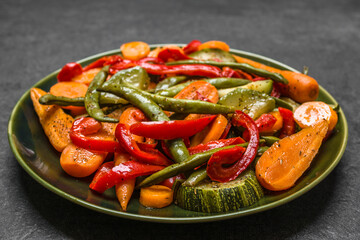 Stir fry vegetables, closeup of colorful, mixed vegetables. Asian food on plate. Low calorie diet concept.