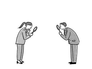 虫眼鏡を持ったスーツを着た男性と女性