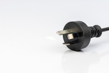 Electric plug with three pins isolated on a white background