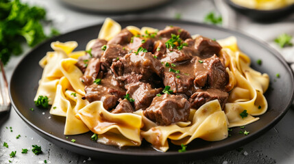 Hearty european meal: delicious latvian beef stroganoff with ribbon noodles and chopped parsley garnish