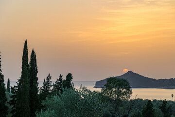 Sunset over the sea and the bay of Agios Georgios on the island of Corfu