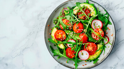 Fresh raw vegetables on a plate, a close-up view of an avocado salad, tomato and arugula from above.