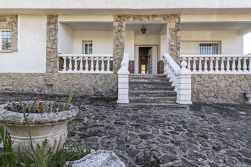 Main facade of chalet with plot with granite stone floors and access staircase with white cement...