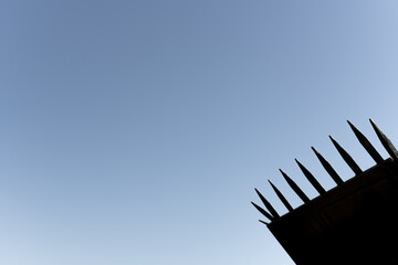 Backlit spikes on top of a perimeter fence