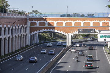 Urban entrance road to Madrid with traffic information monitor and indicative signage and a large...