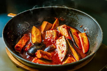 eggplants in tomato sauce cooked in frying pan