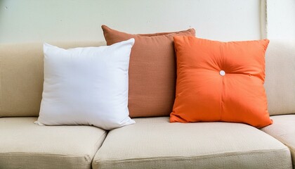 minimal Close-up of fabric sofa with white and terra cotta pillows. French country home