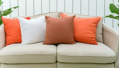 minimal Close-up of fabric sofa with white and terra cotta pillows. French country home