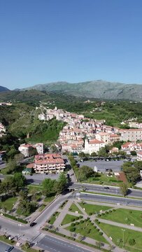 approaching flight vertical aerial view about an ancient sea old town of Scalea