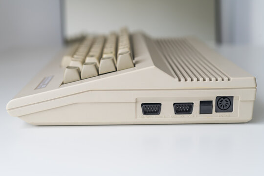 A side view of a vintage computer with visible ports, illuminated by daylight. Perfect for illustrating computer hardware, technology concepts, and connectivity.