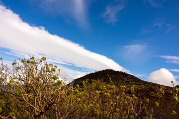 clouds over the mountains blue sky background with grass in front in Big Island Hawaii USA