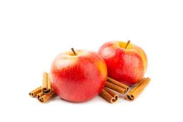 Apples with cinnamon isolated on white background. Fragrant red spiced apples with cinnamon sticks and star anise. Apple slices with spicy spices. Place for text. Harvesting. Fruits. Vegan.