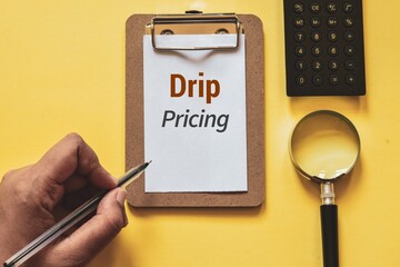 Drip pricing note on yellow background. A deceptive way of selling strategy in digital marketing by...
