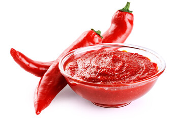 Gochujang Korean traditional spicy fermented sauce in a bowl and chili pepper isolated on white...