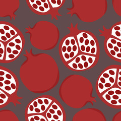 Modern pomegranate fruits cut and whole on a dark background
