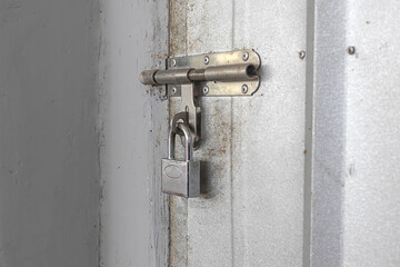 Door lock with rusty key on iron door