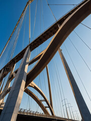 Architectural Marvel, Bridge Photographed from Below Against Azure Sky, Exemplifying Civil Engineering Feat