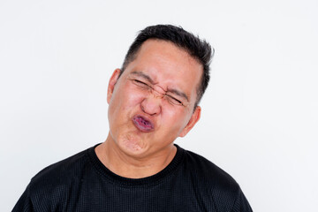 Middle-aged Asian man pouting and closing eyes in a playful kiss gesture, isolated on white