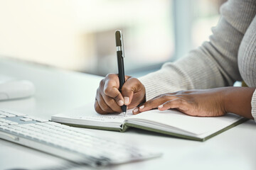 Business woman, hands and writing with book for reminder, schedule planning or record keeping at...