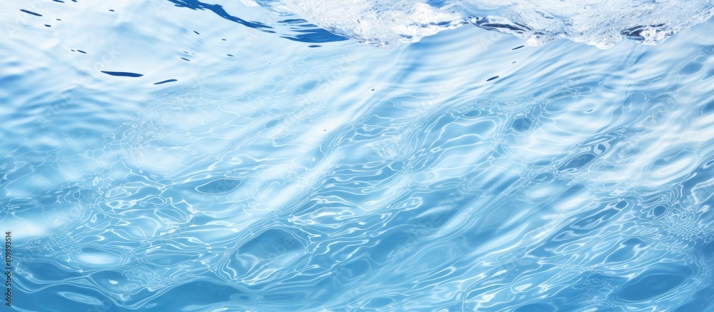 Aufkleber Top view of a clear water surface with rippling patterns set against a light blue background creating a visually appealing copy space image