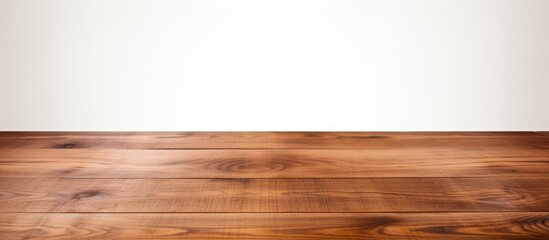 A brown wooden tabletop is situated on a white background with plenty of space for images. Creative banner. Copyspace image