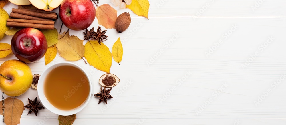 Aufkleber Top view of a cup of tea adorned with lemon honey autumn leaves and apples placed on a white background This flat lay image captures the essence of autumn with ample copy space for any desired text