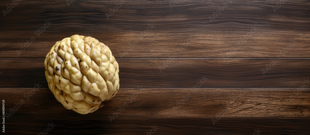 Aufkleber a ripe cherimoya fruit placed on a wooden table with a top down view the image has copy space and a 