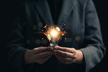 A light bulb that shines in your hand. The concept of finding new ideas to create innovation....
