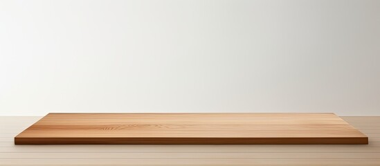 A black paper bag rests on a clean white wooden table creating a perfect space for adding text