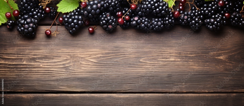 Poster a frame with a copy space image for inscription on a wooden table displaying fresh organic berries i