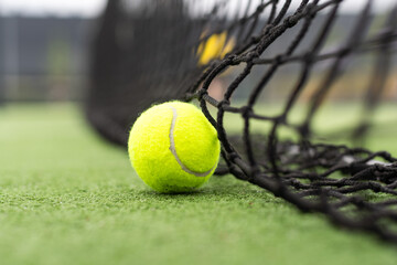 Tennis Ball on the Court against the Court Net