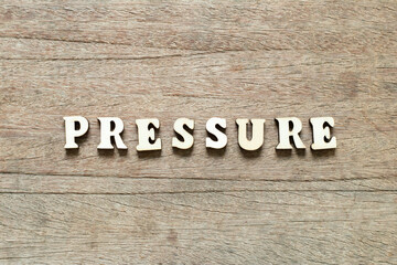 Fototapeta premium Alphabet letter block in word pressure on wood background