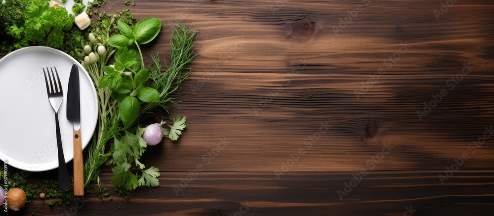 Aufkleber Copy space image of a wooden background with a white plate adorned with a fork and spoon alongside fresh herbs and greens as ingredients for cooking