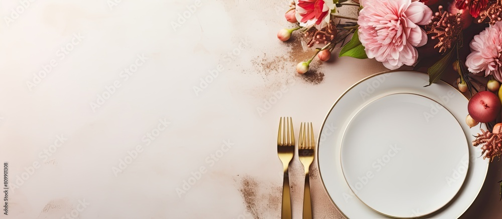 Poster a festive table is set with a white plate and cutlery accompanied by a beautiful floral arrangement 