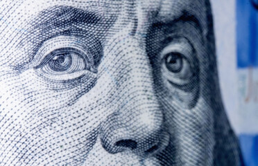 Macro image of eyes of Benjamin Franklin on the one hundred US Dollar bill. Close up horizontal...