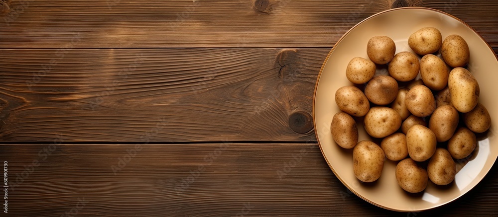Aufkleber A copy space image featuring a plate of uncooked potatoes is placed on a rustic wooden table