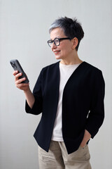 A confident businesswoman using her smartphone with style and professionalism.