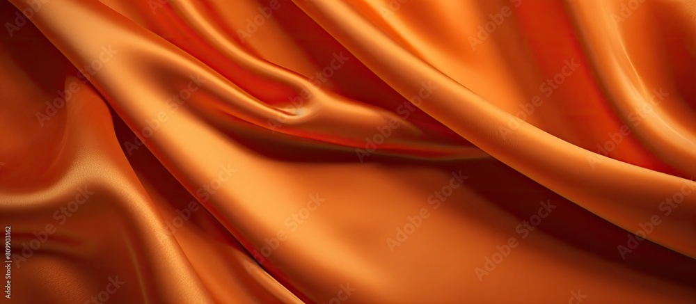 Poster An expensive luxury fabric in a rich orange color with a velvet texture set against a background that offers ample empty space for a copy
