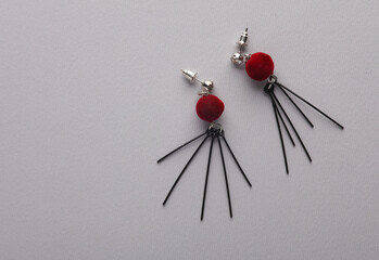 Stylish earrings on a gray background. Top view