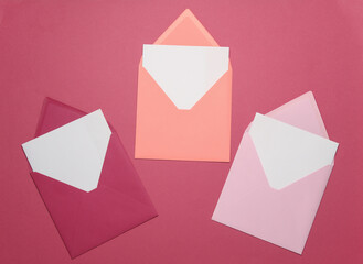 Pink envelopes with white blank letters on a pink background. Creative layout