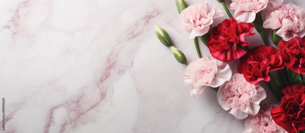 Poster top view of a stunning bouquet of pink and red carnations on a marble table this beautiful arrangeme