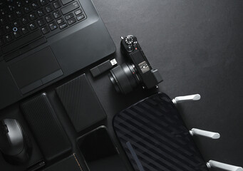 Modern gadgets and accessories in black. Laptop, camera, smartphone, external hard drive, USB flash...